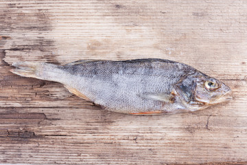 dried fish on the old wood Board