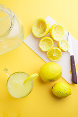 Water and lemon in yellow background