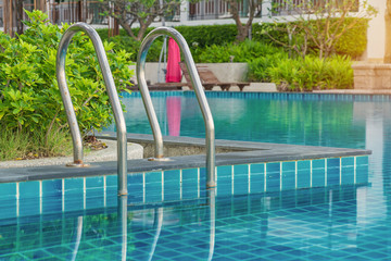 Fototapeta na wymiar blue swimming pool at hotel with stair