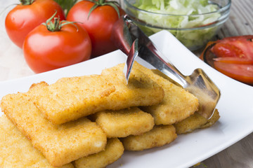 Meat croquettes served with fresh vegetables.