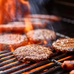 flame broiled hamburger patties cooking on grill