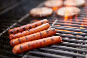 grilling hot dogs over open flame