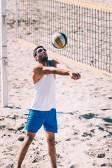 Male beach volleyball player in action