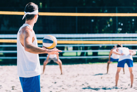 Beach volleyball men's game, player serving