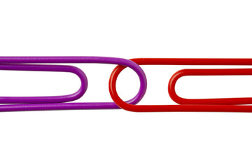 cropped image of two paper clips against white.