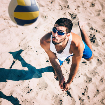 Beach Volleyball Male Player In Action, Receiving The Ball