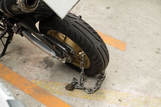 Fototapeta padlock security lock blocking the motorcycle wheel on street