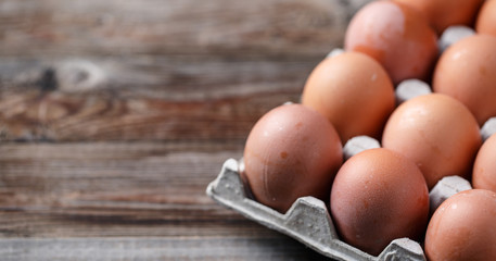 Brown eggs on a rustic wooden table