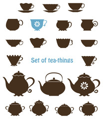 Set of silhouettes of cups, tea-pots and sugar bowls. Vector contour.