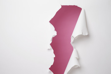 White paper ripped in studio with pink background