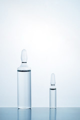 Medical ampoules on blue background