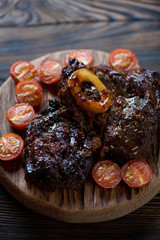 Close-up of osso buco with baked tomatoes, selective focus