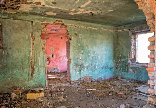 Old and abandoned green room with bad rooftop and light coming through the window