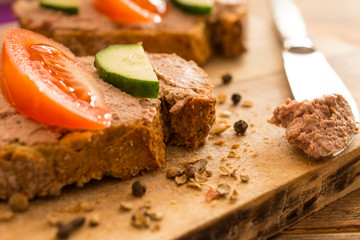 Sandwiches with meat pate on wooden cutting board