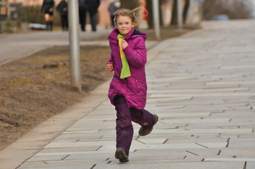 Young girl running the street - 107123827