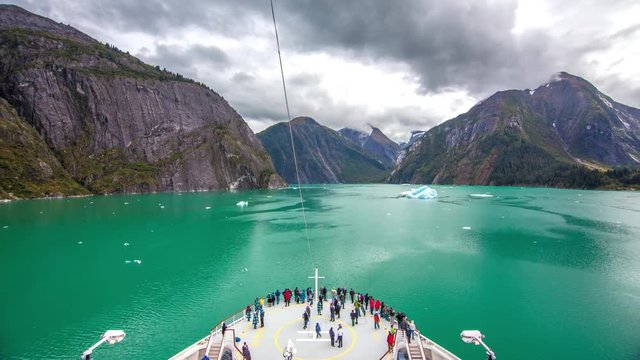 Alaska Tracy Arm Fjord Cruising Timelapse Part 1 Featuring the View from the Front of a Cruise Ship with Passengers on the Bow Enjoying the Scenery towards Sawyer Glacier.