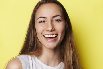Beautiful and smiling young woman in studio