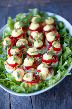 Deviled eggs on a salad leaves on a plate