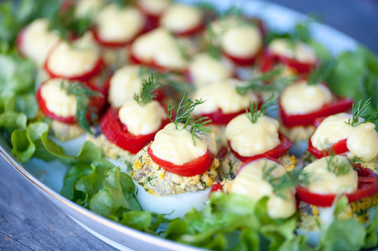 Deviled eggs on a salad leaves on a plate