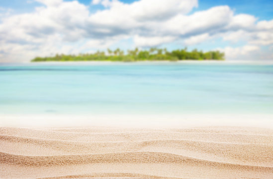 Sandy tropical beach with island on background