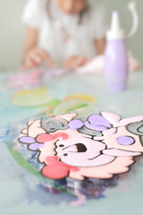 Blurry of young girl doing artwork with color . defocused and