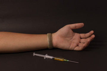 syringe of drug and dead arm