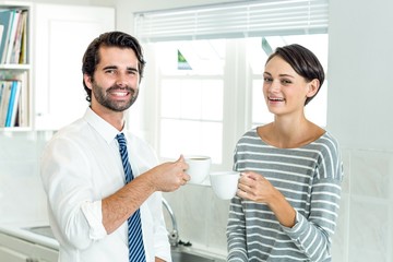 Obraz na płótnie Canvas Portrait of businessman with woman enjoying coffee