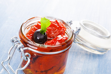 Dry tomatoes in oil in jar.