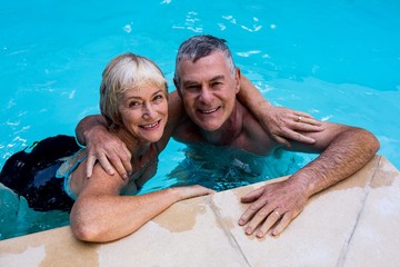 Senior couple swimming in pool 