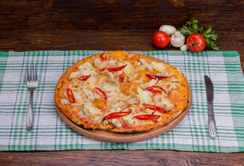 spicy pizza on a wooden background