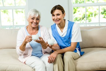 Portrait of smiling nurse with senior woman