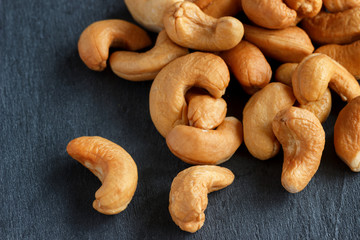 Roasted cashew nuts on dark background