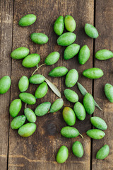 Fresh green olives on wooden table from above