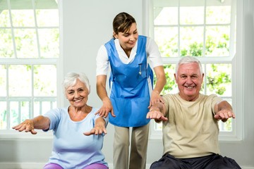 Fototapeta premium Nurse assisting senior man and woman