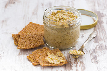 homemade mustard in a glass jar and crackers