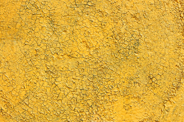 Shelled and cracked old painted yellow surface