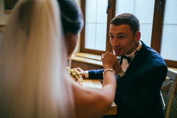 Just married couple embrace, wedding pair hugging, Bride and Groom, Romantic Married Couple in restaurant, holding hands, beautiful couple in the hotel , They Hug each other, wedding