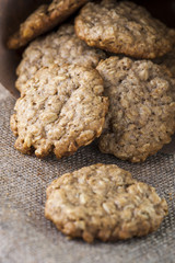 Heap of oatmeal cookies on brown napkin