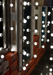 The mirrors with lamps in the dressing room.