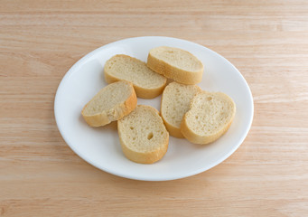 Small slices of French bread on a white plate