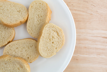 Small slices of French bread on a white plate