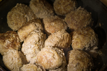 Fresh meat cutlets in a frying pan. Selective focus.