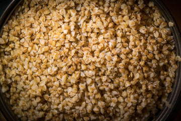 Cooking buckwheat groats on a stove. Selective focus.