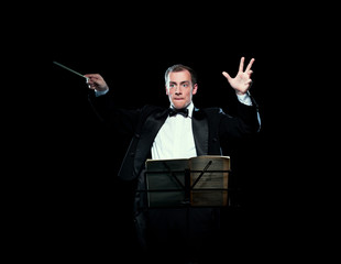 Shot of music director conducting with inspiration