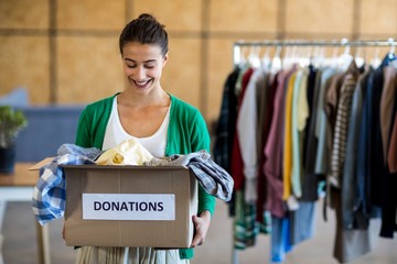 Young woman with donation box