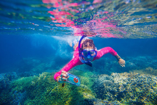 Underwater photo of girl with camera