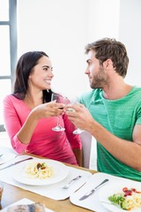 Young couple toasting wine glasses 
