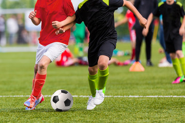 Fototapeta na wymiar Young boys play soccer football match