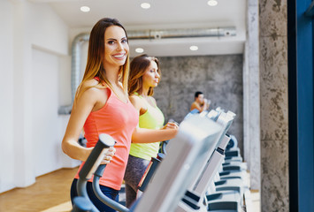 Happy women doing cardio workout at gym