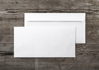 Blank envelopes on wooden background. Back and front view. Template for ID. Top view. For design presentations and portfolios.